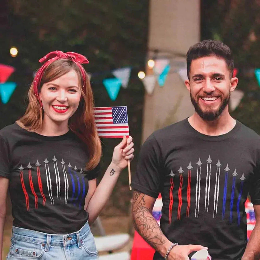 Adults wearing matching black t-shirts with red, white, and blue jet flyover graphic and American flag.