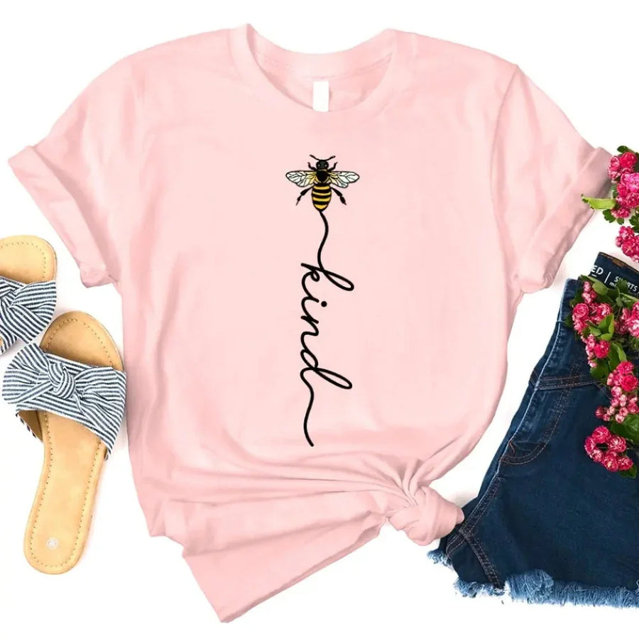 May include an inspirational t-shirt design featuring the phrase “Bee Kind” in flowing script lettering, often paired with a small bee graphic that adds a gentle, uplifting touch to the message.