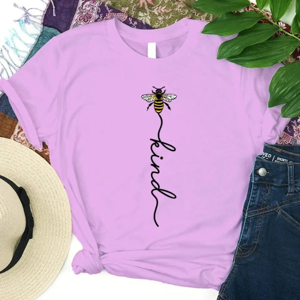 May include an inspirational t-shirt design featuring the phrase “Bee Kind” in flowing script lettering, often paired with a small bee graphic that adds a gentle, uplifting touch to the message.