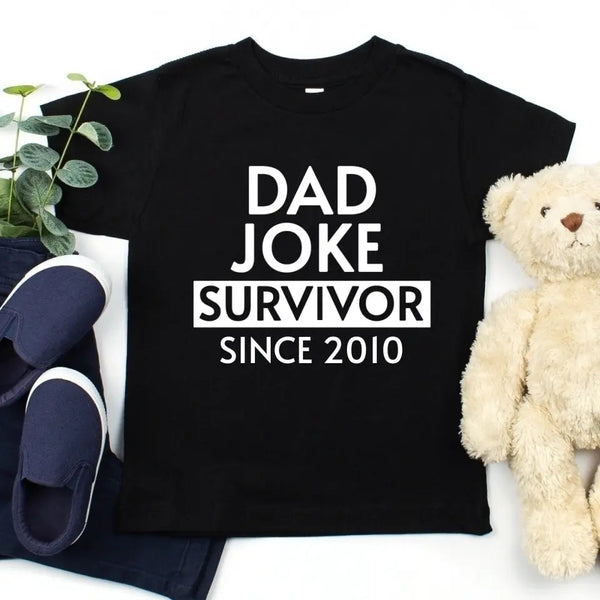 May include a father and family wearing matching t-shirts with a “Dad Jokes” graphic.