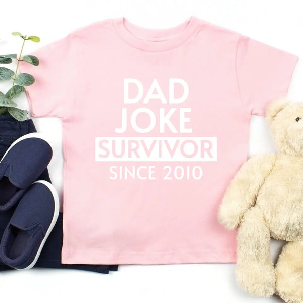 May include a father and family wearing matching t-shirts with a “Dad Jokes” graphic.