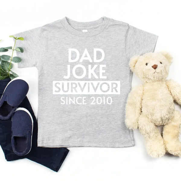 May include a father and family wearing matching t-shirts with a “Dad Jokes” graphic.