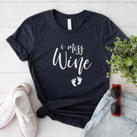 Dark grey graphic tee with 'I miss wine' and baby footprints, styled with denim shorts and sneakers