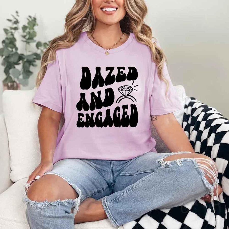 May include Lilac group in colorful tie-dye shirts reading “Dazed & Engaged,” smiling at a bachelorette party, with bride in veil and fun, festive vibe!