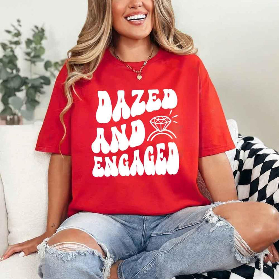 May include Red group in colorful tie-dye shirts reading “Dazed & Engaged,” smiling at a bachelorette party, with bride in veil and fun, festive vibe!