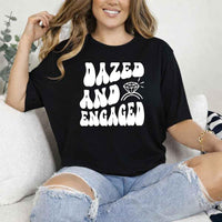 May include Black group in colorful tie-dye shirts reading “Dazed & Engaged,” smiling at a bachelorette party, with bride in veil and fun, festive vibe!
