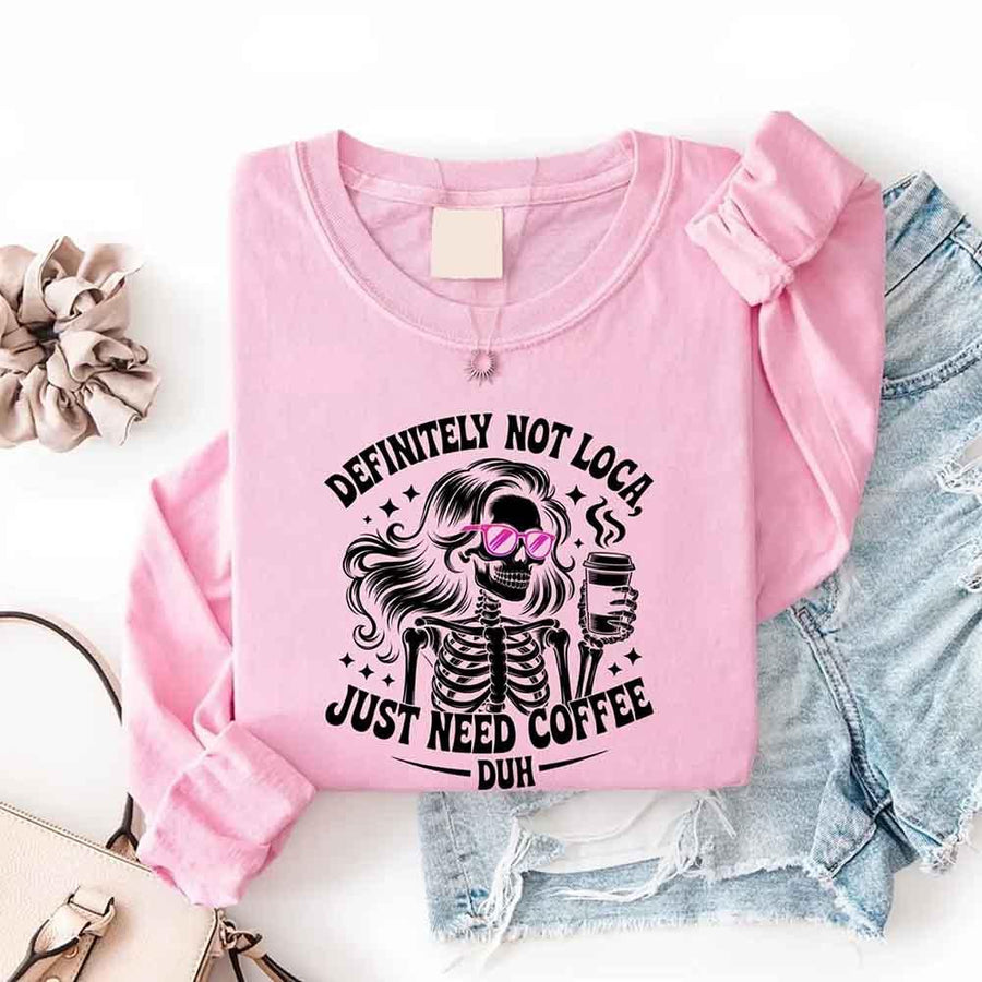 May include a women’s long sleeve shirt with the phrase “Definitely Not Loca” printed on the front in a casual, stylish design.