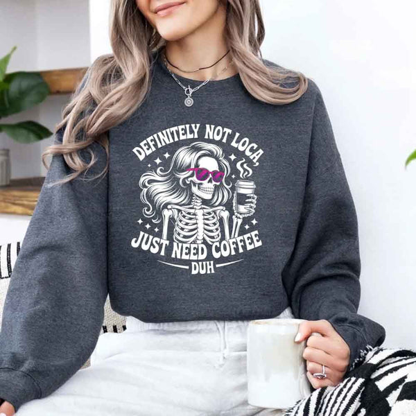 May include a women’s long sleeve shirt with the phrase “Definitely Not Loca” printed on the front in a casual, stylish design.