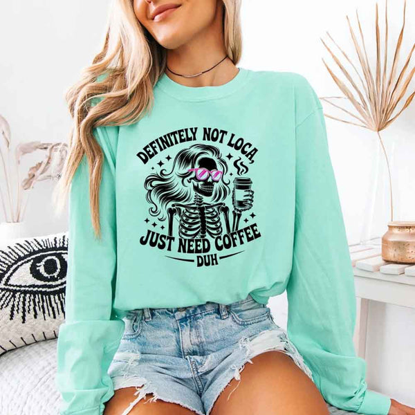 May include a women’s long sleeve shirt with the phrase “Definitely Not Loca” printed on the front in a casual, stylish design.