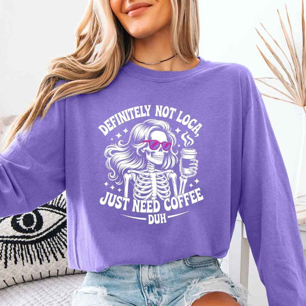 May include a women’s long sleeve shirt with the phrase “Definitely Not Loca” printed on the front in a casual, stylish design.
