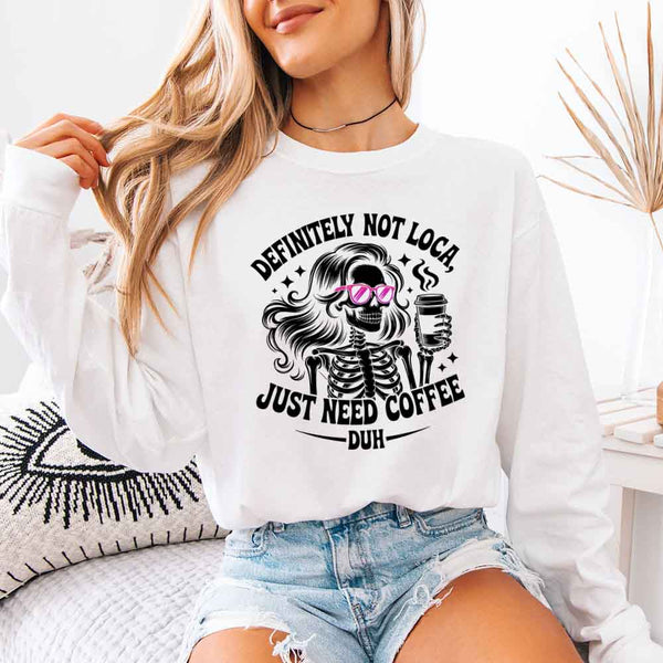 May include a women’s long sleeve shirt with the phrase “Definitely Not Loca” printed on the front in a casual, stylish design.