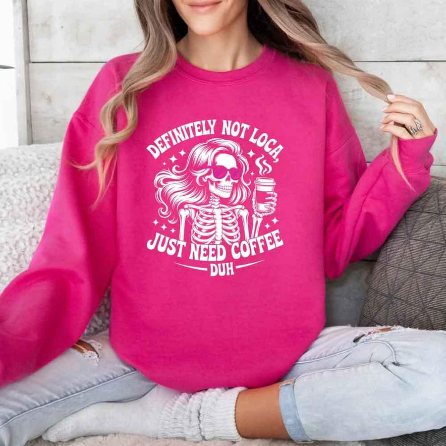 May include a women’s long sleeve shirt with the phrase “Definitely Not Loca” printed on the front in a casual, stylish design.