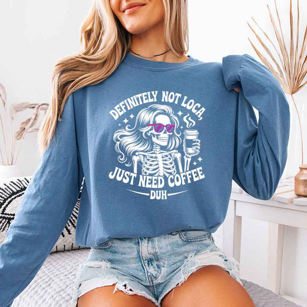 May include a women’s long sleeve shirt with the phrase “Definitely Not Loca” printed on the front in a casual, stylish design.