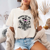 May include a short sleeve graphic tee featuring the phrase “Definitely Not Loca”  on a casual unisex shirt.
