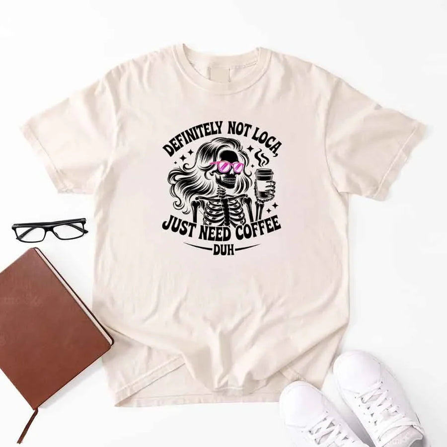 May include a short sleeve graphic tee featuring the phrase “Definitely Not Loca”  on a casual unisex shirt.