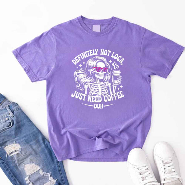 May include a short sleeve graphic tee featuring the phrase “Definitely Not Loca”  on a casual unisex shirt.