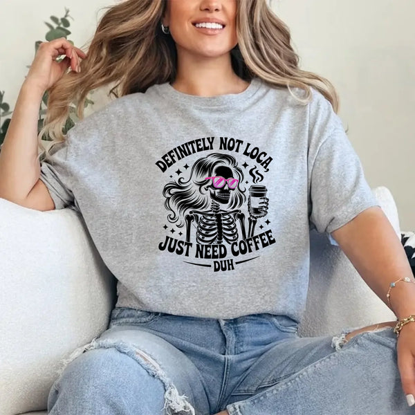 May include a short sleeve graphic tee featuring the phrase “Definitely Not Loca”  on a casual unisex shirt.