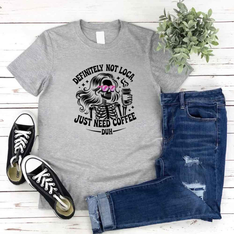 May include a short sleeve graphic tee featuring the phrase “Definitely Not Loca”  on a casual unisex shirt.
