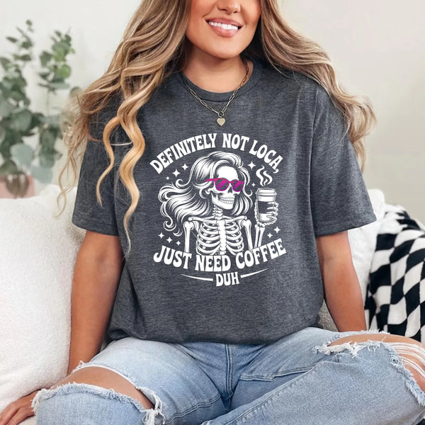 May include a short sleeve graphic tee featuring the phrase “Definitely Not Loca”  on a casual unisex shirt.