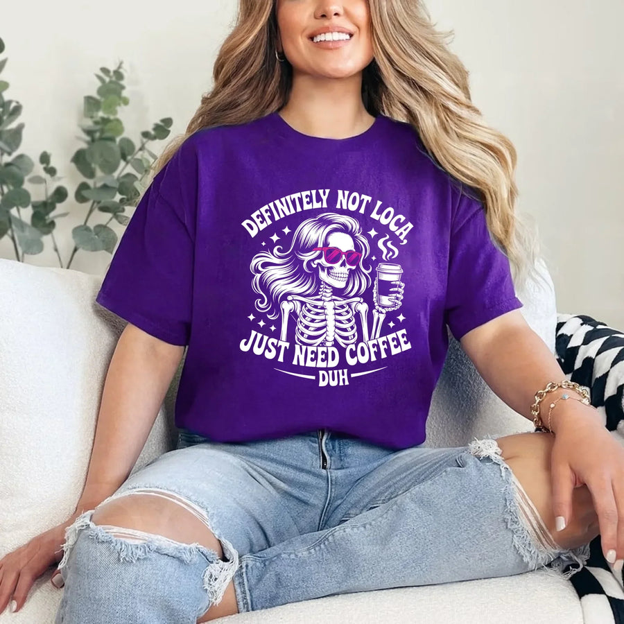 May include a short sleeve graphic tee featuring the phrase “Definitely Not Loca”  on a casual unisex shirt.
