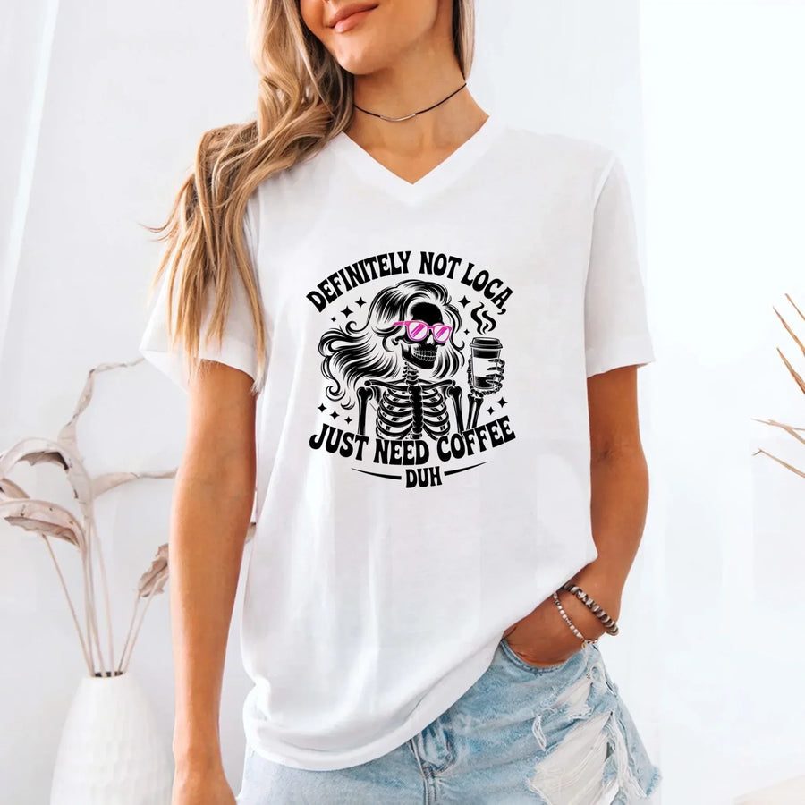 May include a short sleeve graphic tee featuring the phrase “Definitely Not Loca”  on a casual unisex shirt.