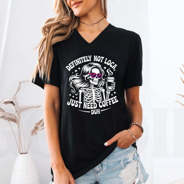 May include a short sleeve graphic tee featuring the phrase “Definitely Not Loca”  on a casual unisex shirt.