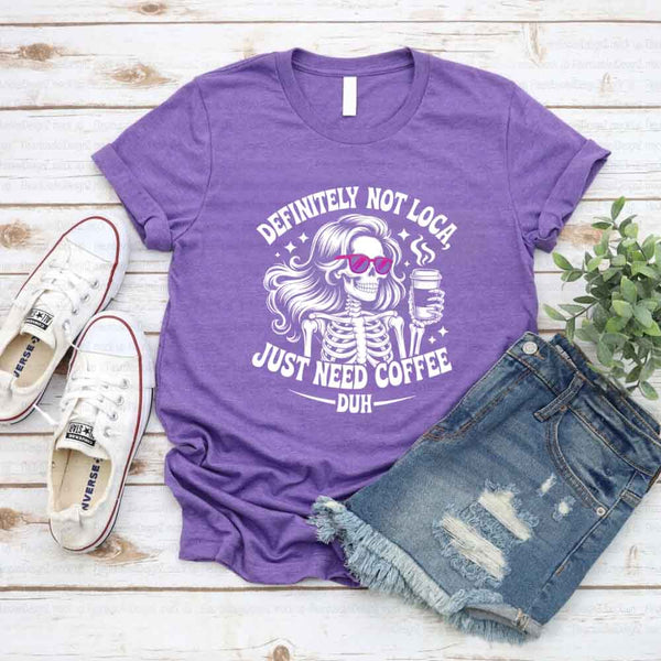 May include a short sleeve graphic tee featuring the phrase “Definitely Not Loca”  on a casual unisex shirt.