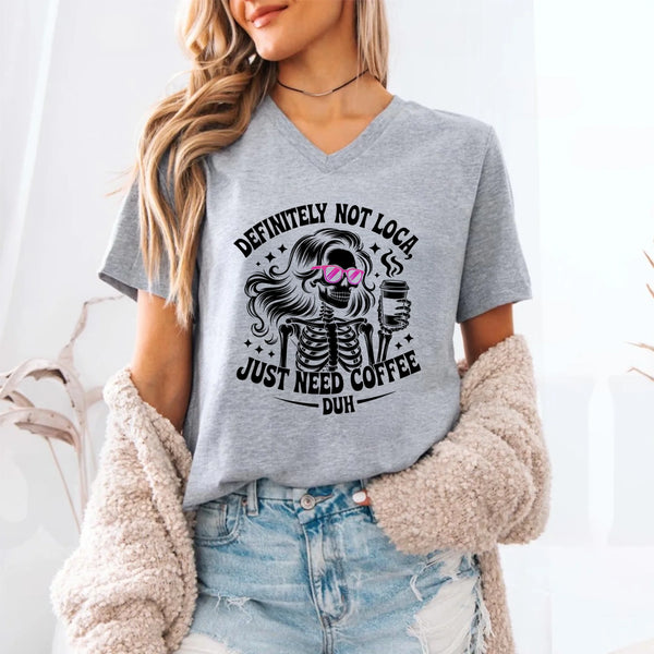 May include a short sleeve graphic tee featuring the phrase “Definitely Not Loca”  on a casual unisex shirt.