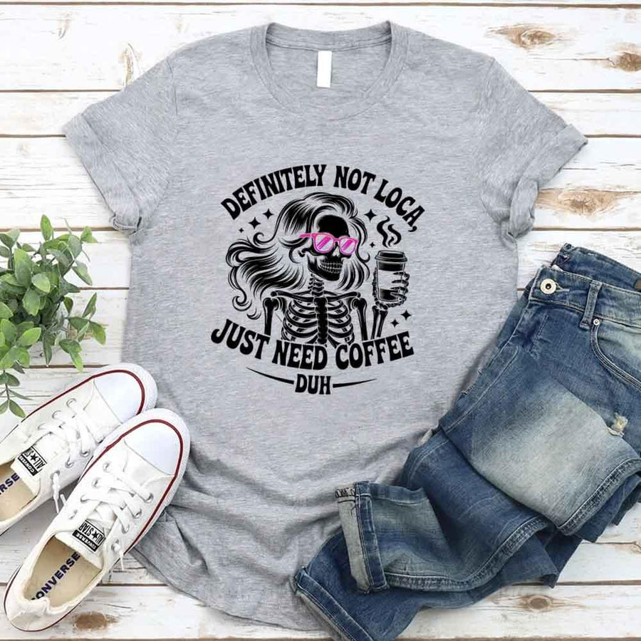 May include a short sleeve graphic tee featuring the phrase “Definitely Not Loca”  on a casual unisex shirt.