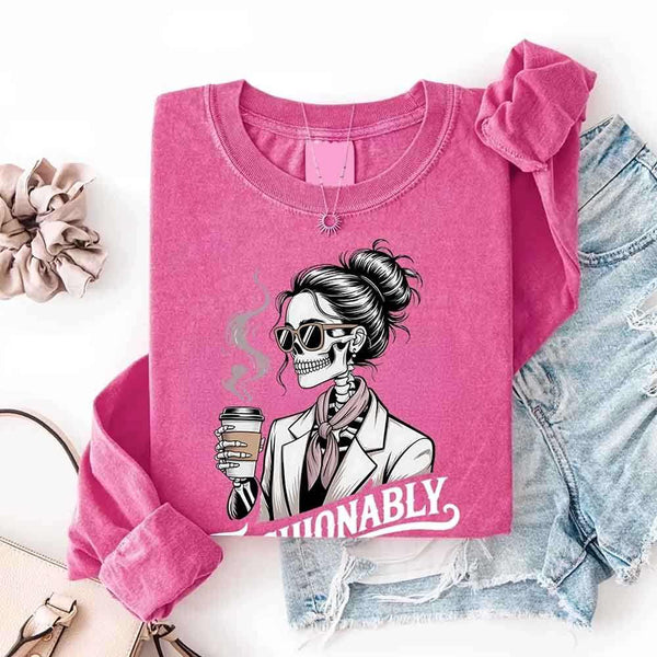 May include a long sleeve shirt featuring the phrase “Fashionably Late” in a stylish, modern font.