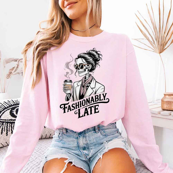 May include a long sleeve shirt featuring the phrase “Fashionably Late” in a stylish, modern font.