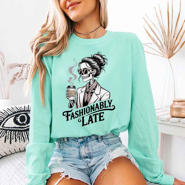 May include a long sleeve shirt featuring the phrase “Fashionably Late” in a stylish, modern font.