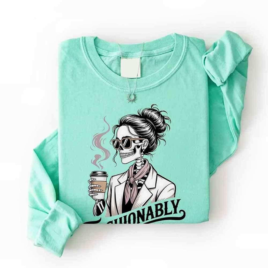 May include a long sleeve shirt featuring the phrase “Fashionably Late” in a stylish, modern font.