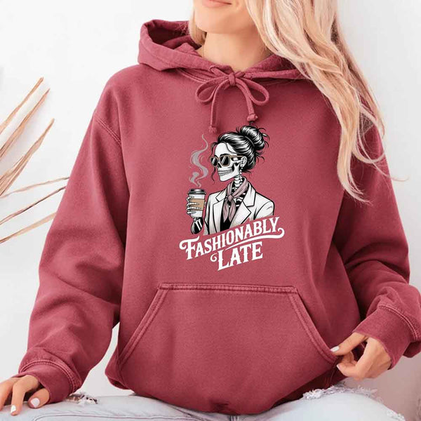 May include a long sleeve shirt featuring the phrase “Fashionably Late” in a stylish, modern font.