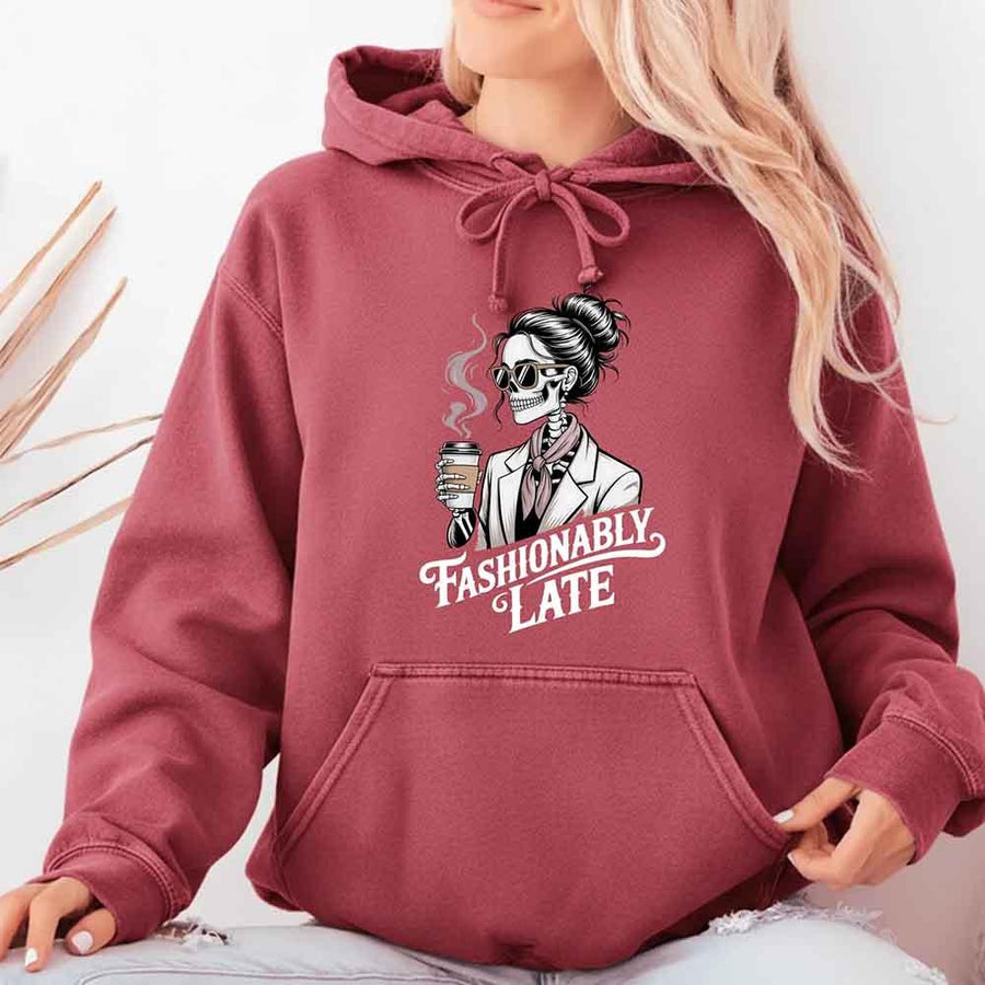 May include a long sleeve shirt featuring the phrase “Fashionably Late” in a stylish, modern font.