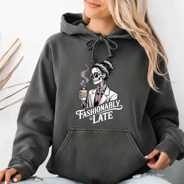 May include a long sleeve shirt featuring the phrase “Fashionably Late” in a stylish, modern font.