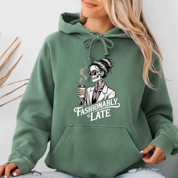 May include a long sleeve shirt featuring the phrase “Fashionably Late” in a stylish, modern font.