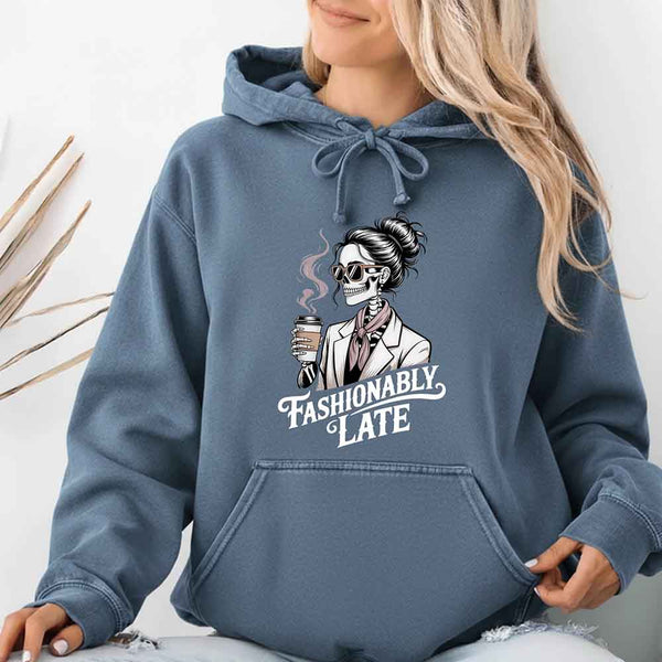 May include a long sleeve shirt featuring the phrase “Fashionably Late” in a stylish, modern font.