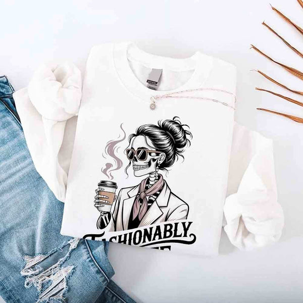 May include a long sleeve shirt featuring the phrase “Fashionably Late” in a stylish, modern font.