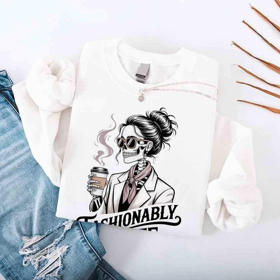 May include a long sleeve shirt featuring the phrase “Fashionably Late” in a stylish, modern font.