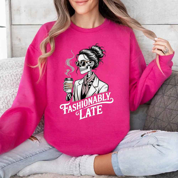 May include a long sleeve shirt featuring the phrase “Fashionably Late” in a stylish, modern font.