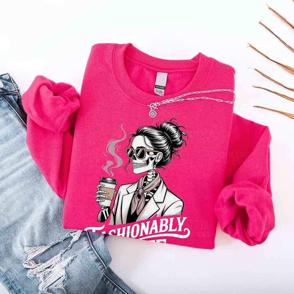 May include a long sleeve shirt featuring the phrase “Fashionably Late” in a stylish, modern font.