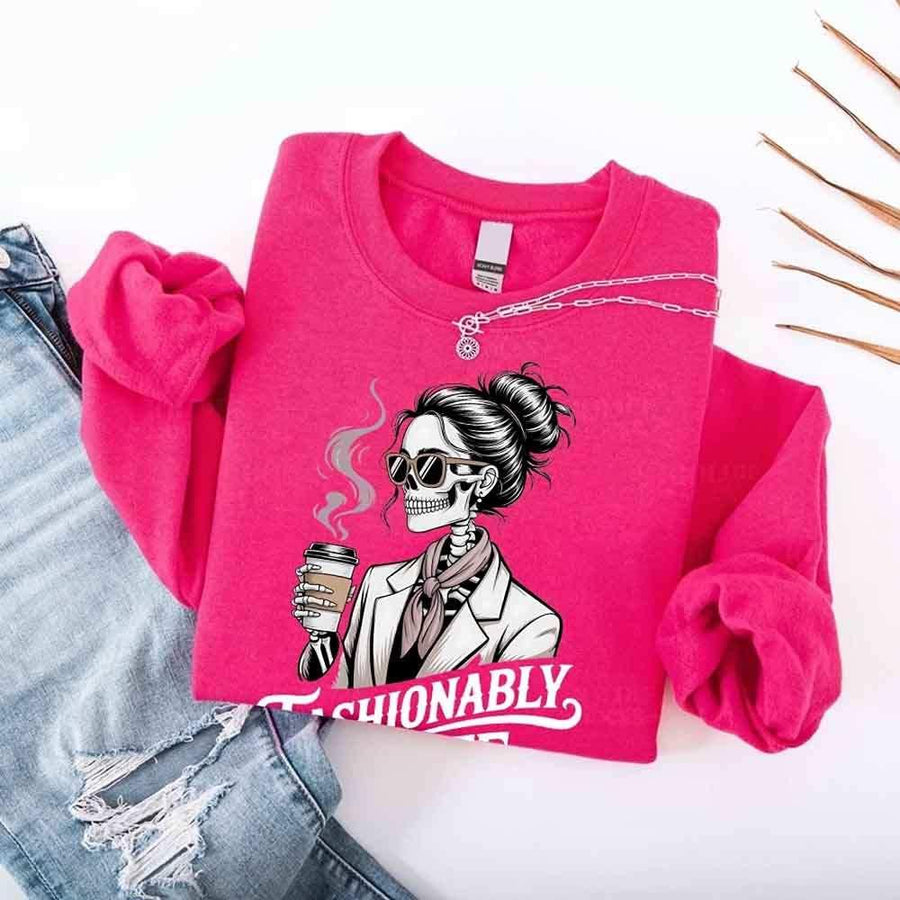 May include a long sleeve shirt featuring the phrase “Fashionably Late” in a stylish, modern font.
