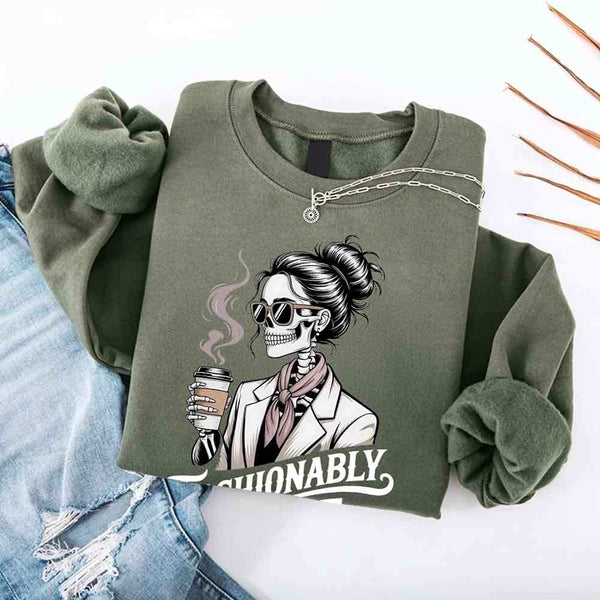 May include a long sleeve shirt featuring the phrase “Fashionably Late” in a stylish, modern font.