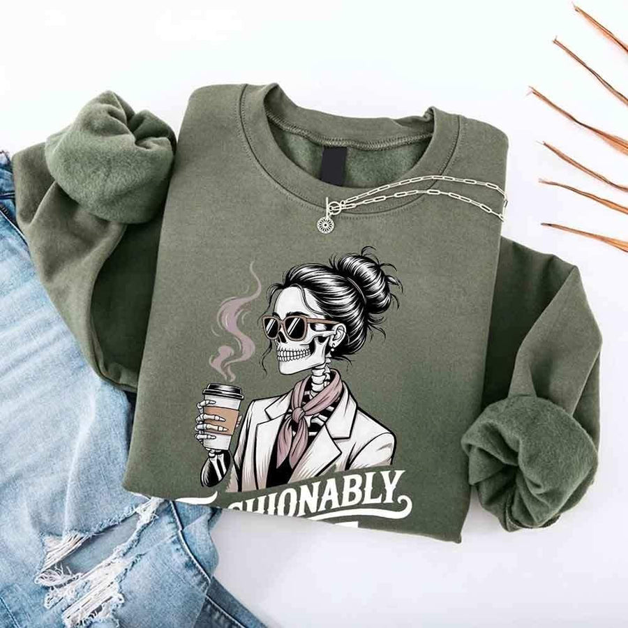 May include a long sleeve shirt featuring the phrase “Fashionably Late” in a stylish, modern font.