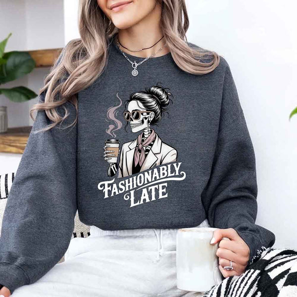 May include a long sleeve shirt featuring the phrase “Fashionably Late” in a stylish, modern font.