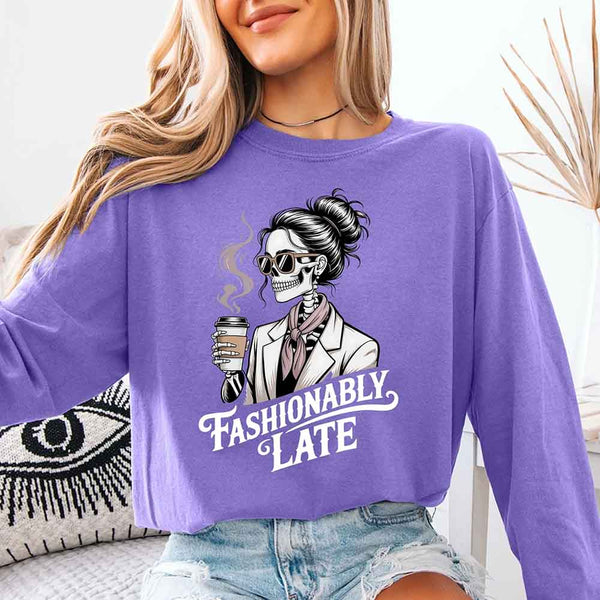 May include a long sleeve shirt featuring the phrase “Fashionably Late” in a stylish, modern font.