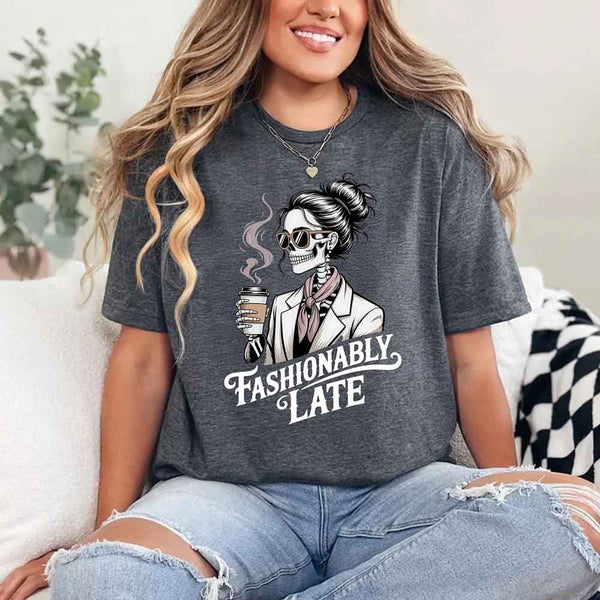 May include a short sleeve shirt featuring the phrase “Fashionably Late” in a stylish, modern font.