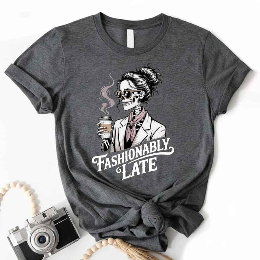 May include a short sleeve shirt featuring the phrase “Fashionably Late” in a stylish, modern font.