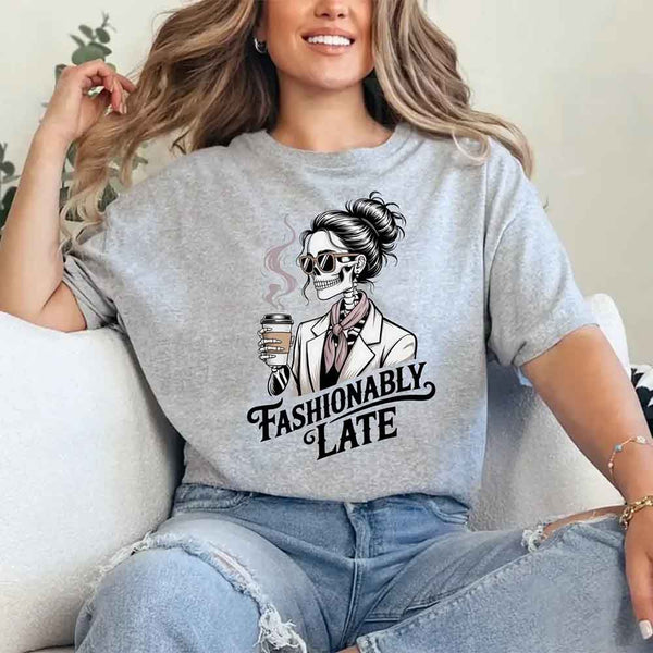 May include a short sleeve shirt featuring the phrase “Fashionably Late” in a stylish, modern font.